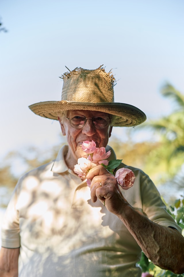 old man smelling a flower after aging counseling