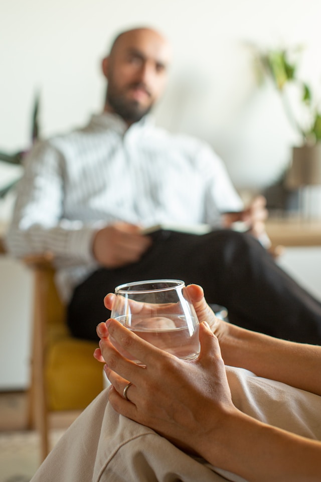 a narcissist sitting starting at his wife showing the need for counseling