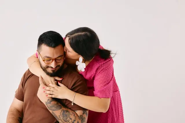 Woman kissing her husband's head embracing after IFS Therapy.